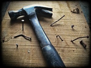 black-claw-hammer-on-brown-wooden-plank-209235-300x225.jpg