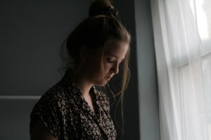 woman-standing-beside-window-curtain-1541212-300x200.jpg