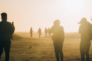 people-walking-on-desert-on-a-windy-day-with-dust-clouding-3046299-300x200.jpg