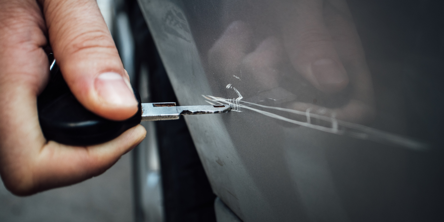 Man keying the car